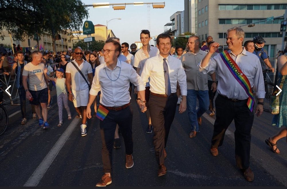  Pete and chasten walk in the Austin Pride Parade 