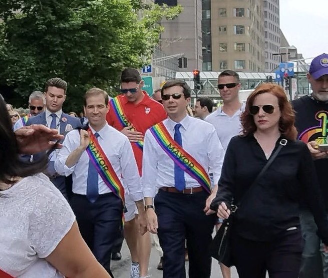 Pete marches with other gay mayors in a Pride parade. 
